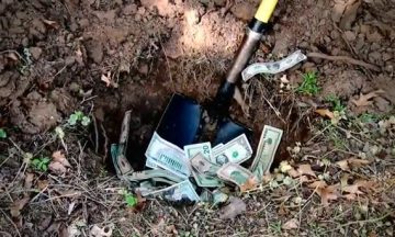 Throwing money into a hole in the ground